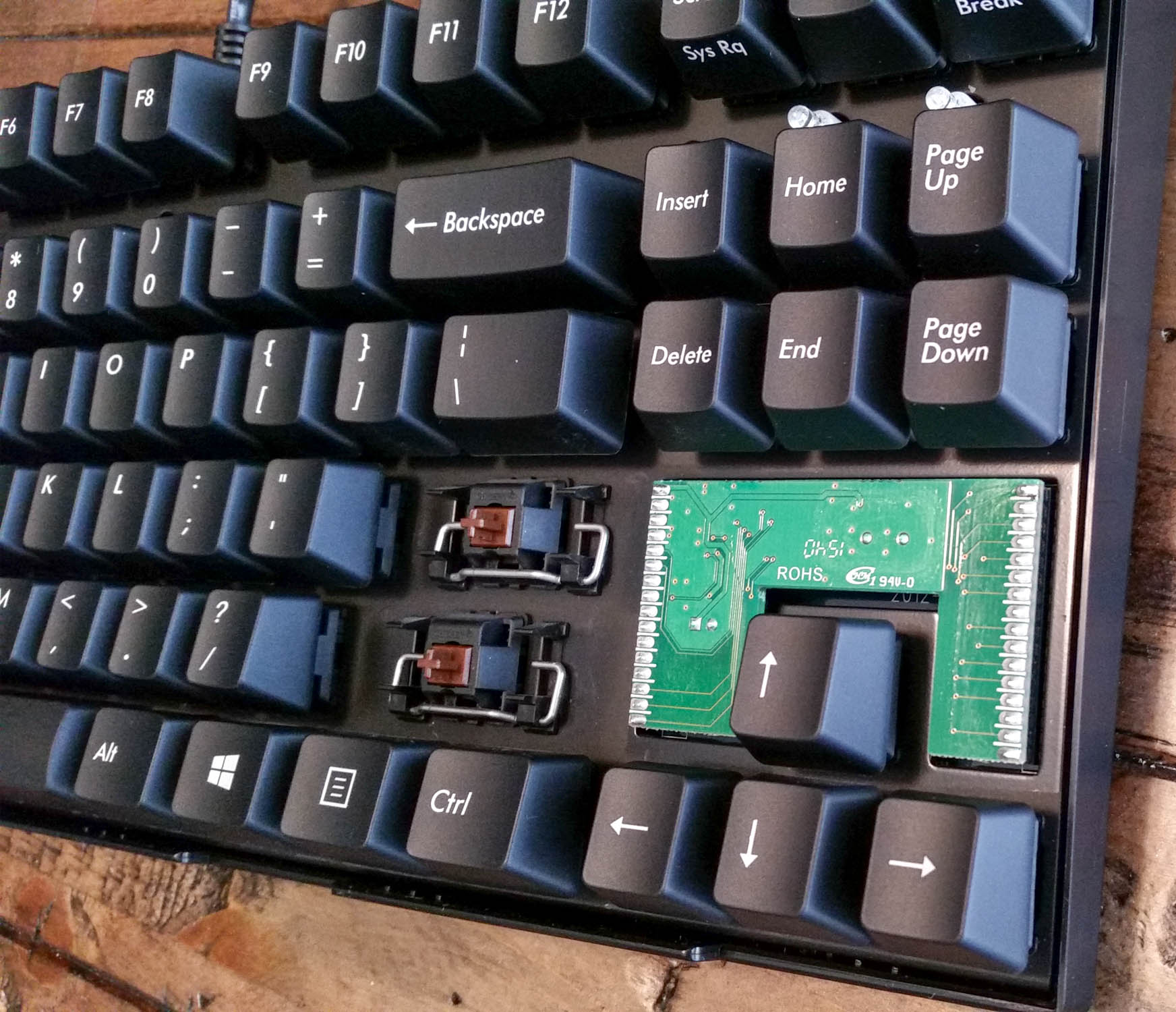The top removed, plus shift and enter keys removed to expose the Cherry Brown key switches. This provides easier access to the controller when removing it.